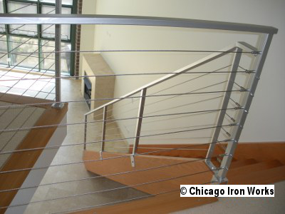 A Modern Cable Railing on a stairway leading to a loft.