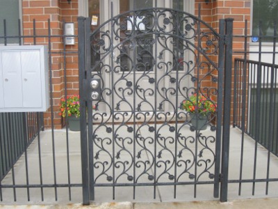An Iron Gate and Fence Restricts Access to an Apartment Building